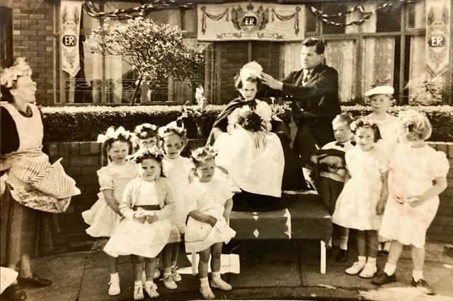 A young Elaine is crowned queen for the day during the 1953 coronation celebrations in Beech Hill. Doing the crowning is rugby legend Joe Egan