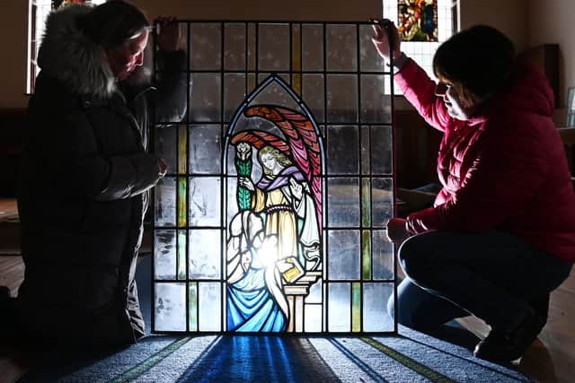 Former church warden Dorothy Harrison, left, and Kerry Garforth, right, secretary of the Friends of Hindley Cemetery, admire one of the windows at St Mary's Church