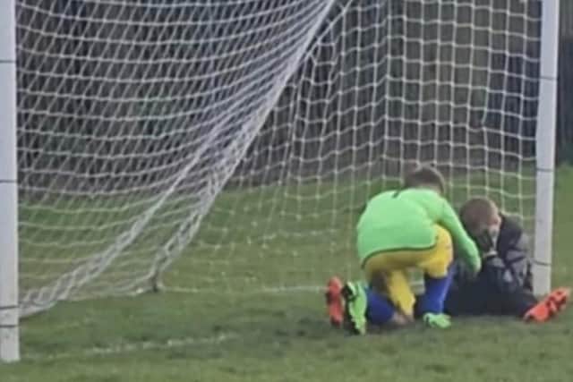 The touching scene between Larson Rushton (11) and his devastated rival was captured on camera