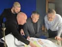 Artists Al and Al show the Haigh Hall masterplan to Coun Chris Ready and James Winterbottom, Wigan Council's director of digital, leisure and well-being