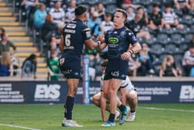Bevan French (left) and Jai Field (right) celebrate a try for Wigan Warriors