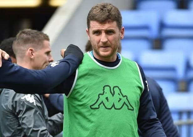 Alex Bruce warms up under the watchful eye of Anthony Barry, now England's assistant manager