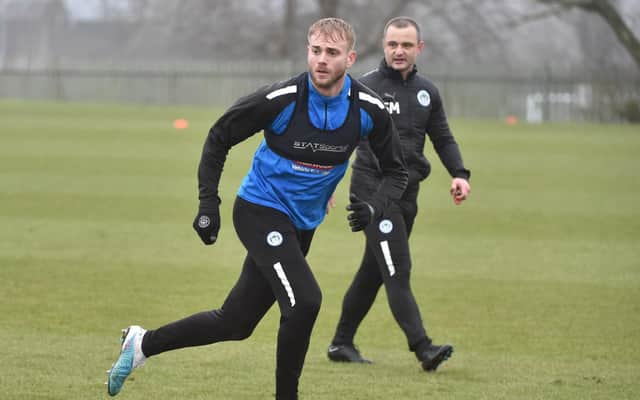 Shaun Maloney watches over Jack Whatmough in training