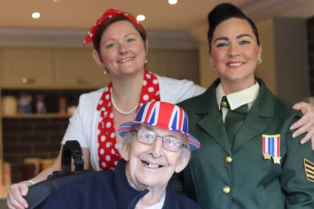 Staff members, Rachel and Sophie, pose for a photo with resident, Gerald Fairhurst all from Lakeside Care Home.