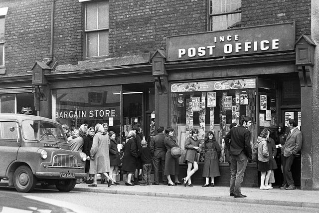 A queue outside Higher Ince Post Office on Manchester Road after a raid on Saturday 10th of April 1971.