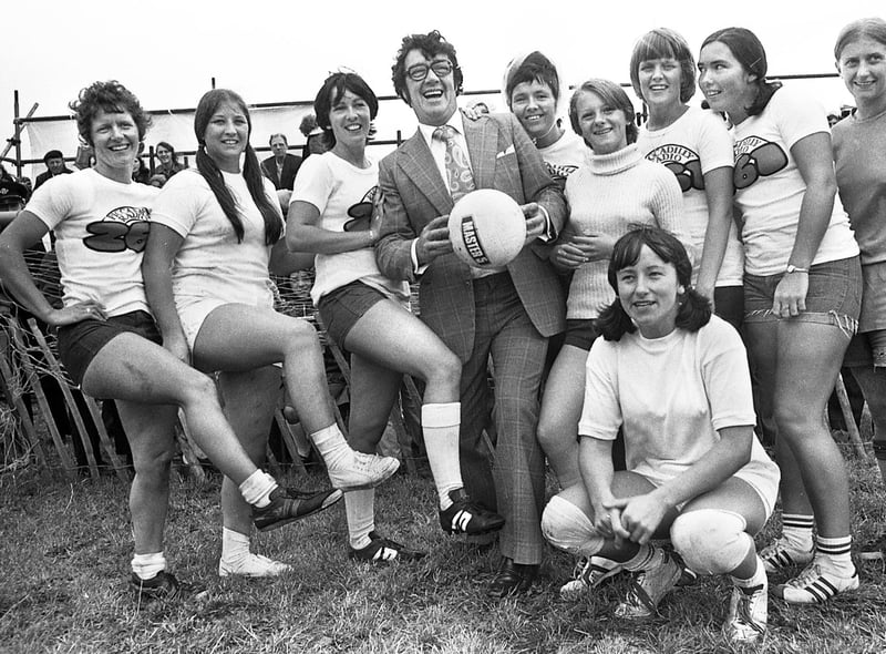 Television comedian Frank Carson with one of the teams competing in an "It's a Knockout" tournament on Bank Holiday Monday 29th of August 1977.
The competition based on the popular television programme at the time involved teams from around the Wigan area taking part in sporty type activities which usually involved getting soapy and wet.