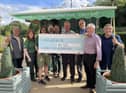 Chairman Ray Hinds (second from right) presents a cheque to staff at Haigh Woodland Park