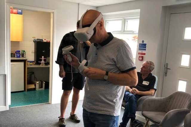 A member of the Generational Gamers Group tries out virtual reality technology