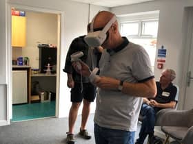 A member of the Generational Gamers Group tries out virtual reality technology