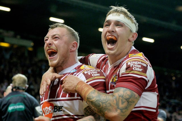Powell celebrates with Josh Charnley during the 2016 Grand Final victory over Warrington Wolves at Old Trafford.