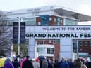 Racegoers queue at Aintree Racecourse, ahead of the opening day of the Randox Grand National Festival