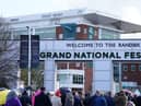Racegoers queue at Aintree Racecourse, ahead of the opening day of the Randox Grand National Festival