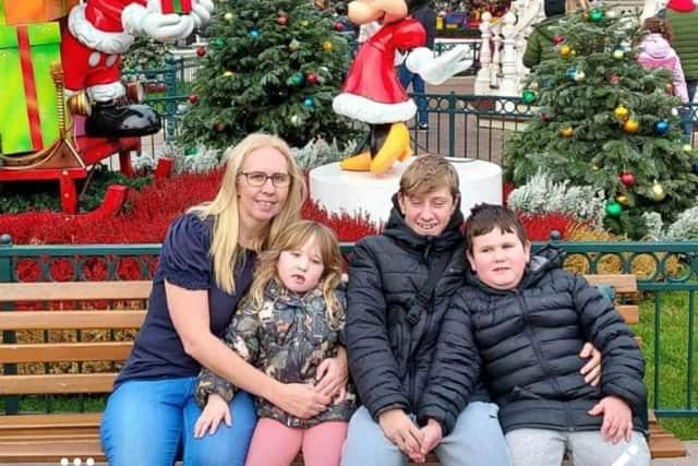Joanne Margerison pictured at Disneyland in January this year with her three children (left to right) Tahlia (five), Oliver (14), and Teddy (seven)