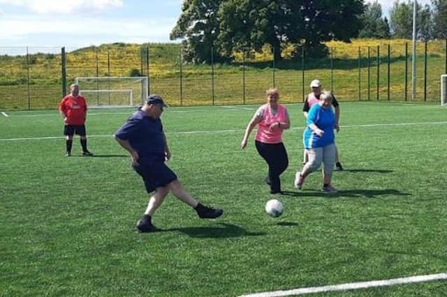 Ready for kick-off: participants from a local walking football session enjoy a kick about | © Stephen Dixon, Wigan Council