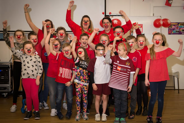 Some of the pupils at RL Hughes with Joanne Millett and Sarah Roberts from Sainsburys celebrating Comic Relief