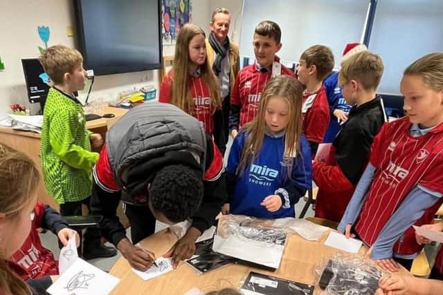 Children wearing shirts donated as part of the Kitmas campaign