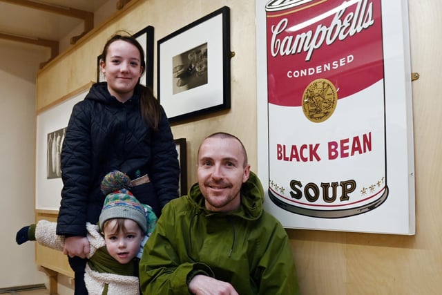 Kevin Cooney with Sophia, 12, and Joseph, three, with some of the art work on display.