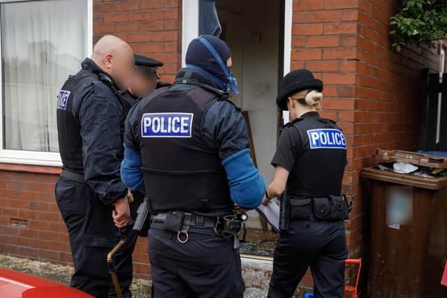 Doors were smashed down as police raided three properties in June