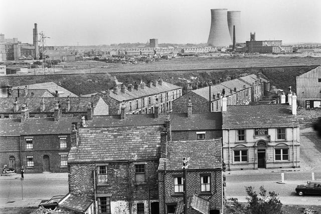 A view in the 1960s of Ormskirk Road, Newtown, in the foreground with the Saddle Inn on the right.  In the background are Westwood power station, with Clifton Mills on the right and St. James church tower behind.