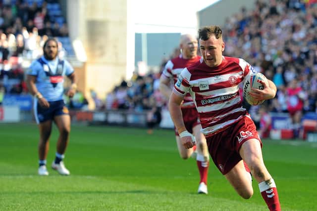 Wigan Warriors' Harry Smith goes in to score his team's first try against St Helens on Good Friday
