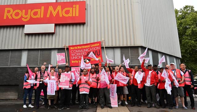 Royal Mail postal workers hold placards and chant slogans as they stand on a picket line outside a delivery office, in north London, on September 8, 2022 during a strike. Picture: JUSTIN TALLIS/AFP via Getty Images.