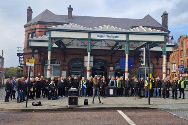 Local Vocals perform outside Wallgate Station in Wigan