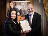 Katie Williams from Winstanley College receiving her high commended award certificate from Sir Jon Coles, chief executive of United Learning and a member of the Bernice McCabe Award judging panel