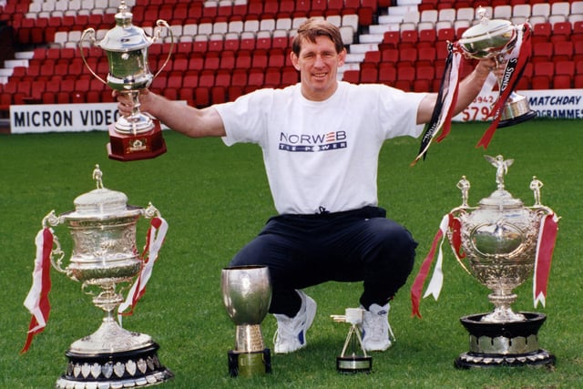 Wigan coach Graeme West with the team's clean sweep of trophies from the 1994-1995 season.
Wigan won every trophy on offer to complete the Grand Slam and in doing so only lost two matches, both away at Leeds and Halifax.
Clockwise from bottom left, League Championship Trophy, World Club Challenge, Stones Bitter Championship, Silk Cut Challenge Cup, BBC TV Team of the Year and Regal Trophy. 

