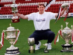 Wigan coach Graeme West with the team's clean sweep of trophies from the 1994-1995 season.
Wigan won every trophy on offer to complete the Grand Slam and in doing so only lost two matches, both away at Leeds and Halifax.
Clockwise from bottom left, League Championship Trophy, World Club Challenge, Stones Bitter Championship, Silk Cut Challenge Cup, BBC TV Team of the Year and Regal Trophy. 
