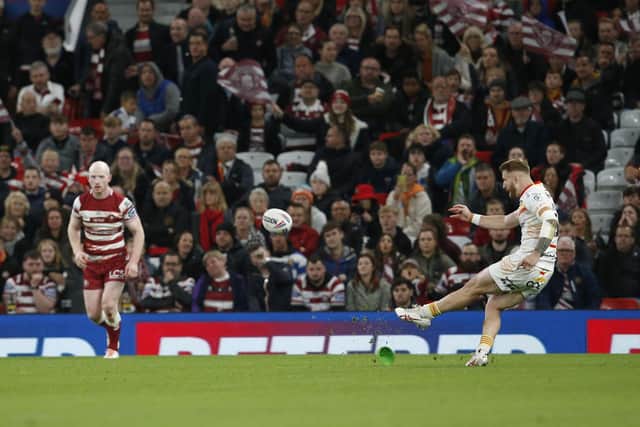 Adam Keighran scores a goal from a penalty for Catalans against Wigan at Old Trafford