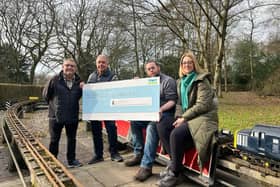 Councillors Chris Ready and Ron Conway hand over the cheque to members of Haigh Woodland Railway Supporters' Association