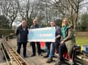 Councillors Chris Ready and Ron Conway hand over the cheque to members of Haigh Woodland Railway Supporters' Association