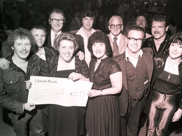Big-hearted Wiganers with a giant cheque for charity raised with a concert of local talent