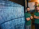 Farhad Sharif (left) and Obid Hussain (right) at Azadi Barber Lounge, Bolton Road, Ashton-in-Makerfield.  The shop front with shutters was intentionally rammed into by a truck, caught on CCTV, causing damage to the shutters and needs a new frontage.