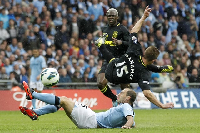 Manchester City's Argentinian defender Pablo Zabaleta (floor) brings down Wigan Athletic's English striker Callum McManaman (top) in a challange that earned him his second yellow card to see him sent off during the English FA Cup final football match between Manchester City and Wigan Athletic at Wembley Stadium in London on May 11, 2013.