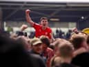 Kell Watts celebrates with the Latics fans after the League One title-winning victory at Shrewsbury last year
