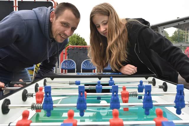 Laimis and Camilla compete on the table football during the Youth Zone's 9th Birthday Open Day.