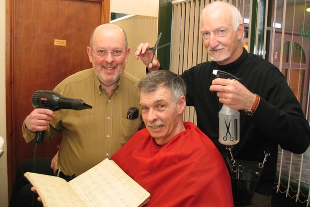 Barry Jackson and Ian Sharrock celebrate 40 years as barbers with one of their original customers, Chris Moss