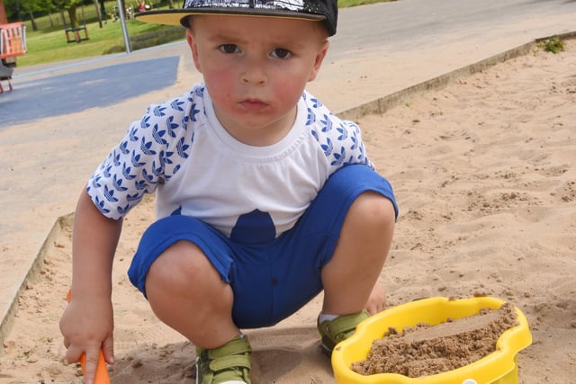 Nathan Bievnocki, three, enjoys the sandpit.
