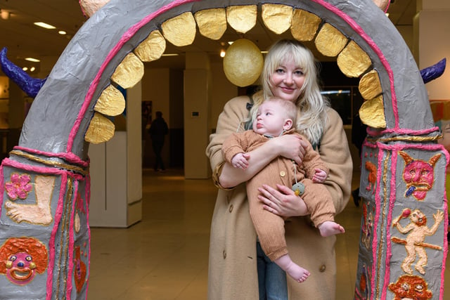 Artist Anna FC Smith with her son Perrin Orrell Smith (six months) inside her art on display