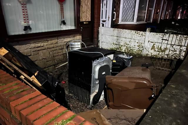 Household appliances are piled outside the flooded homes on Templeton Road, Platt Bridge