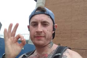 Aaron Woodward does the Andy's Man Club pose during his 75-mile run around the DW Stadium