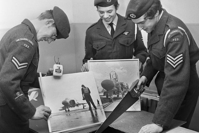 Framing aircraft pictures are, left to right, Cpl. Ian Parkinson, Cpl. Allan Taberner and Sgt. Paul Heyes of the Wigan Air Training Corps squadron on Friday 24th of November 1972.