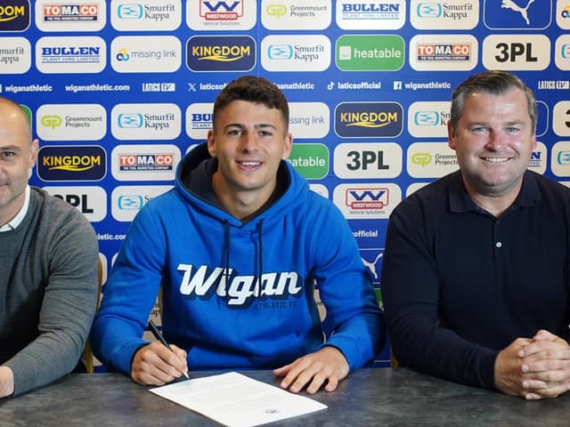 Sam Tickle puts pen to paper on his contract extension watched by Shaun Maloney (left) and Gregor Rioch (right)