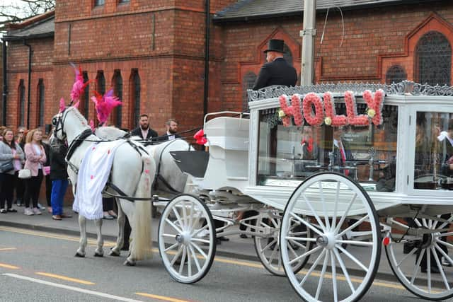 Flowers spelling Holly's name were displayed on the side of the carriage