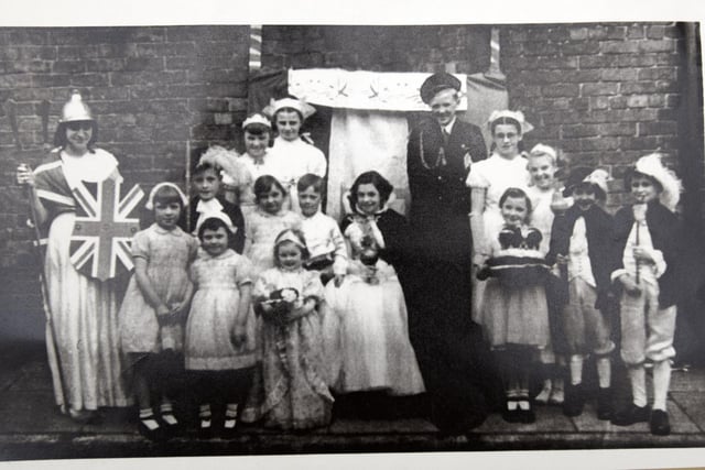 Wigan Observer reader Lois Gregory, pictured as the Queen (centre) with David Flanigan as the Duke of Edinburgh, pictured with children from Chapel Street, Queen Street, Princess Street, Vine Grove and Wood Street, Wigan - celebrating  the Queen's Coronation 70 years ago.