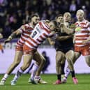 Penrith's Dylan Edwards is tackeld by Wigan's Brad O'Neill