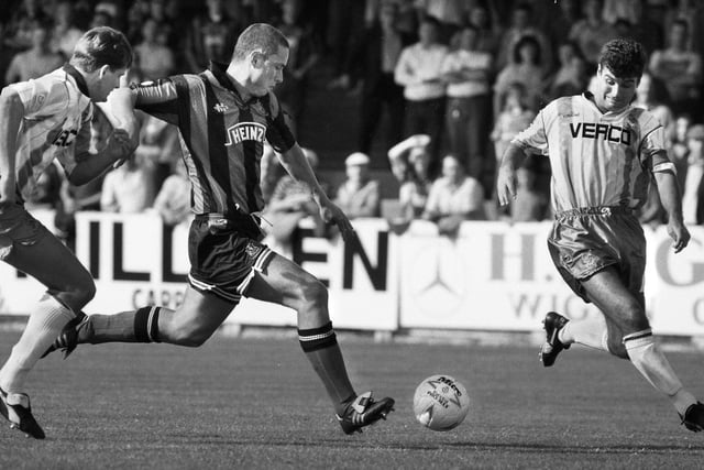 Wigan Athletic defender John Robertson has a crack at goal against Wycombe Wanderers in a 3rd division match at Springfield Park on Saturday 28th of August 1993.
Latics drew 1-1 with Paul Rennie scoring.