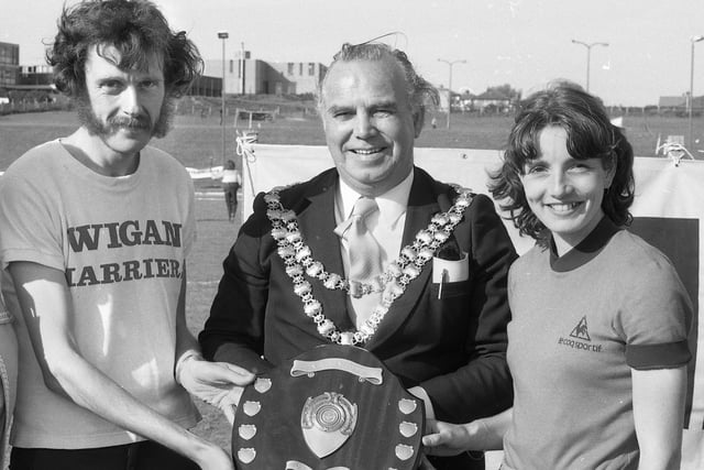 The Mayor of Wigan, Coun. Jim Bridge, presents the team shield to captains, Bill Halsall and Helen Gollop, after Wigan Harriers won the team title at the Visionhire athletics meeting at Woodhouse Stadium on Sunday June 21st 1981. 