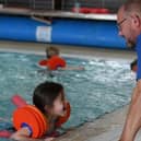 A young girl enjoys a Be Well Learn to Swim session